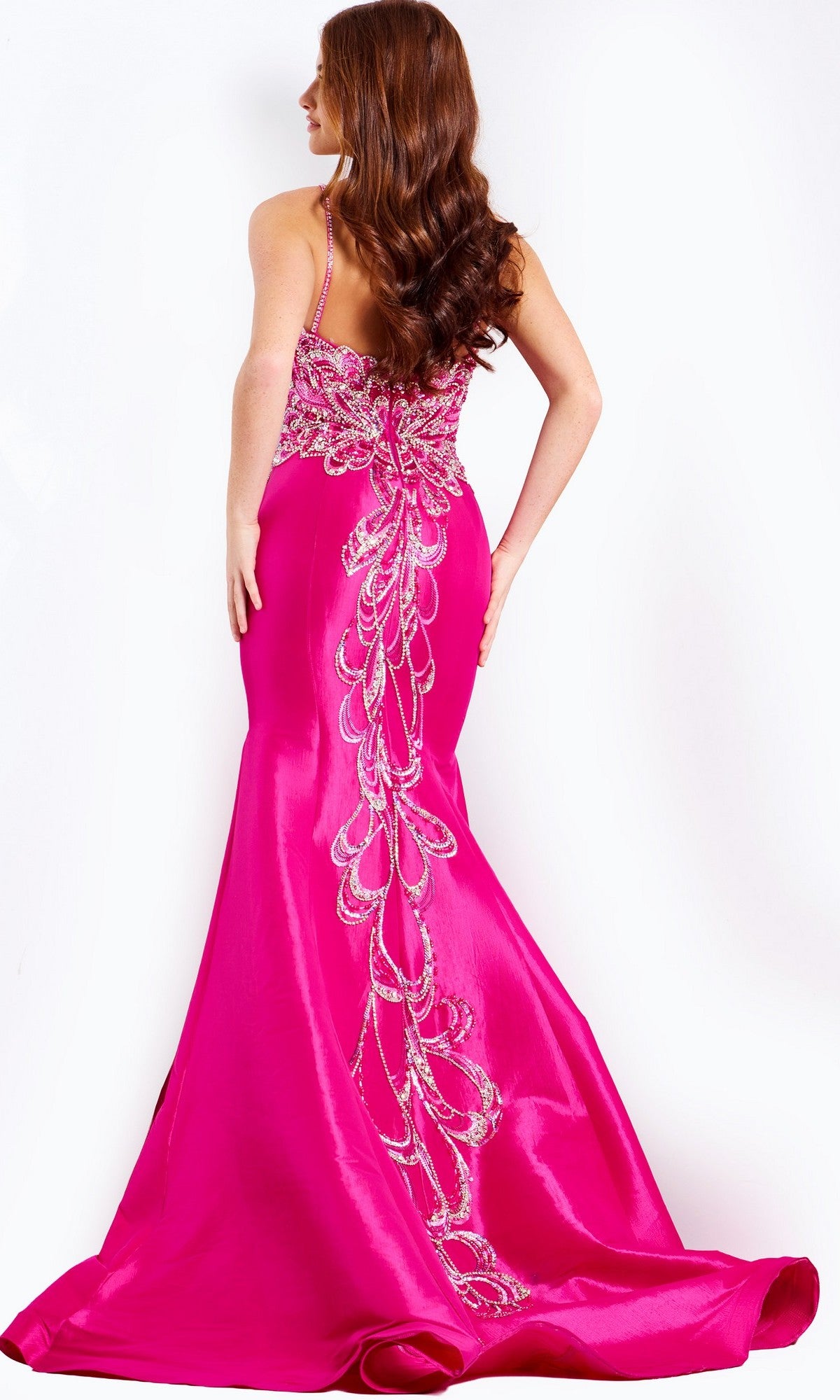 Model wearing the Jovani 44239 long prom dress in bright pink, featuring a sleeveless beaded bodice, floor-length mermaid skirt, and detailed silver beadwork on the back, posed against a plain white background.
